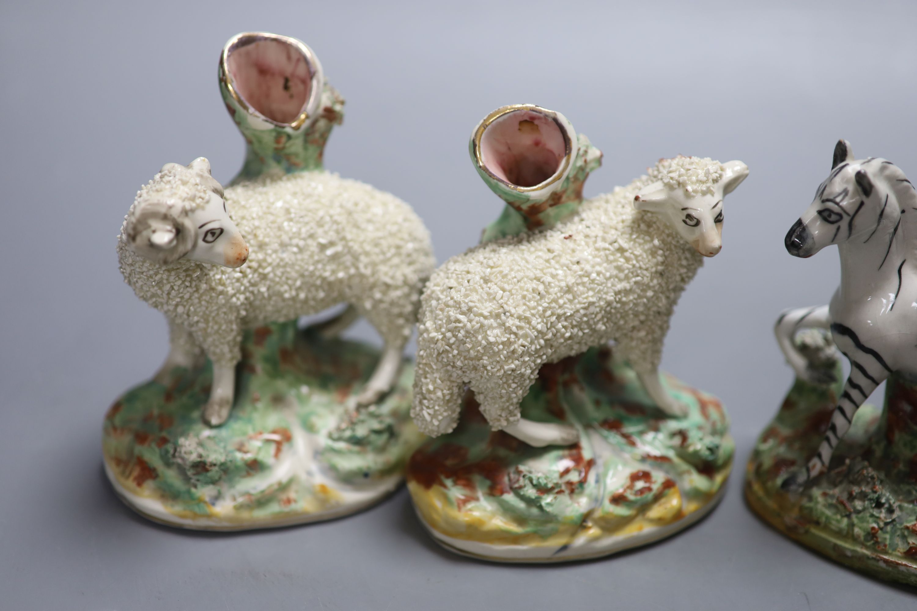 A pair of Staffordshire flatback Zebra and a pair of sheep spill vases